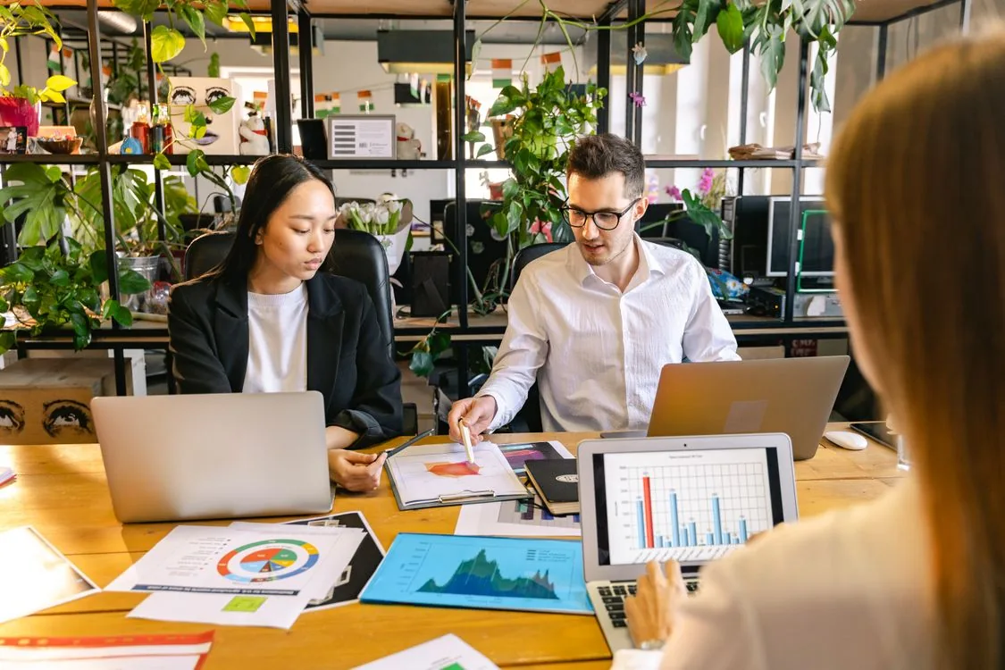Colleagues reviewing business documents together in an office