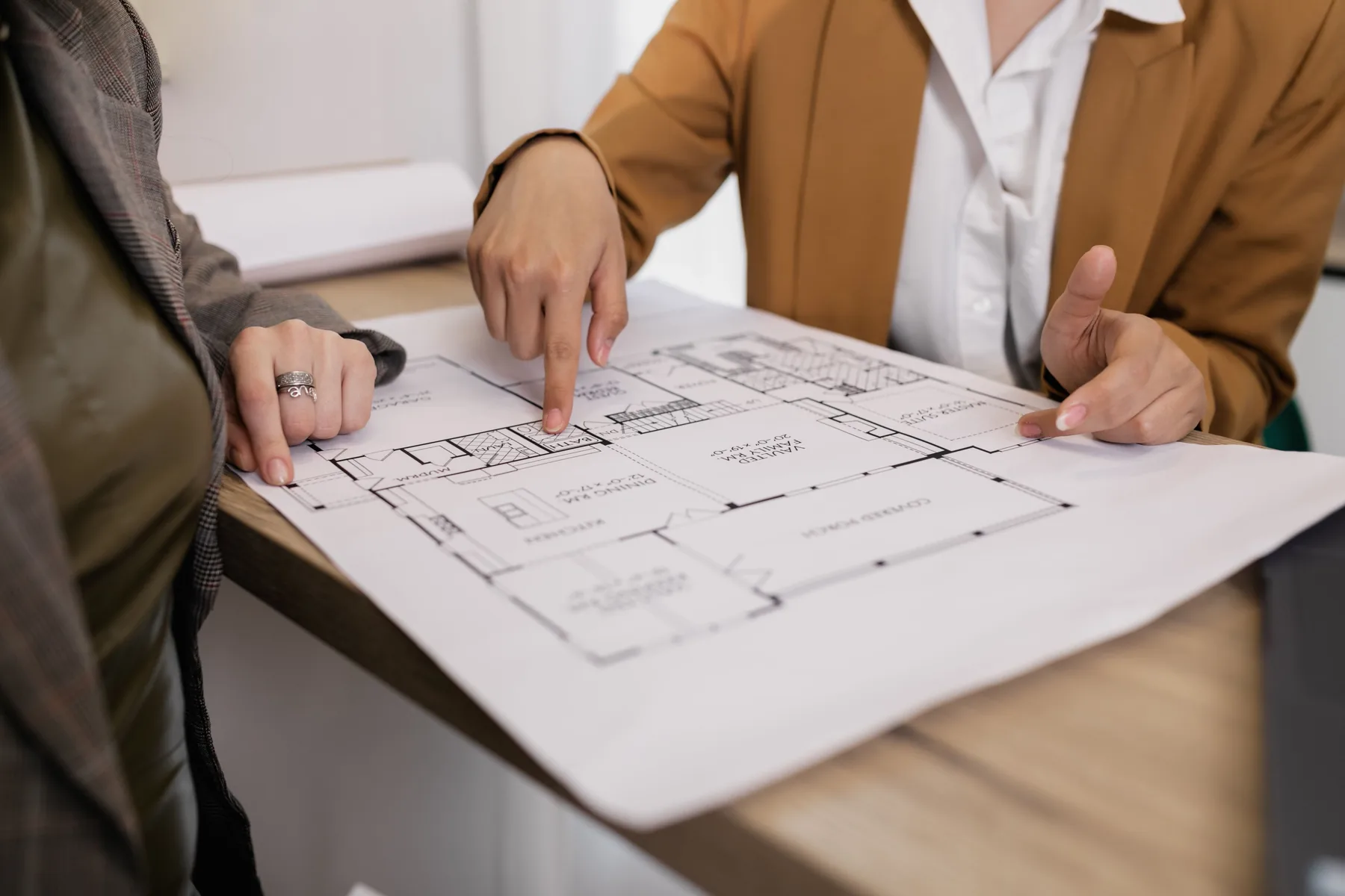 Architectural model and plans being examined with a magnifier